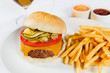 © Michael Marquand - Cheeseburger with cheddar cheese, tomato, pickles and fries