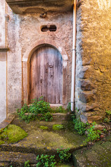 Italy, Sicily, Province of Messina, Novara di Sicilia. A weathered arched door in the medieval hill town of Francavilla di Sicilia.
