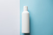© Nastya - white shampoo bottle on a blue and white background. Copy space