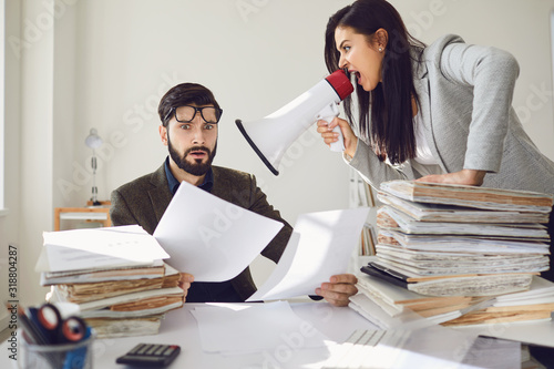 Cuadros en Lienzo Angry boss businesswoman shouting at her office worker in a megaphone in the off