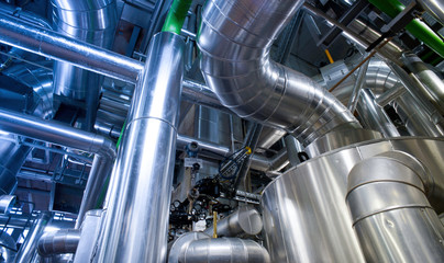 Equipment, cables and piping as found inside of a modern industrial power plant