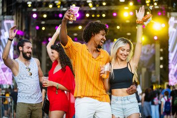 Group of friends having fun time at music festival