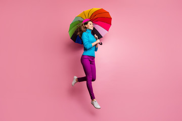 Poster - Full length profile side photo of cheerful girl jump hold shine rainbow umbrella enjoy free time look copyspace wear stylish clothing isolated over pink color background