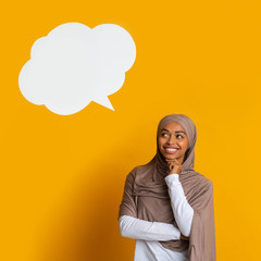 Wall Mural - Empty speech bubble above head of thoughful black muslim woman