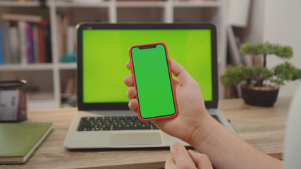 NEW YORK - April 5, 2019:Close up hands man use laptop computer with green screen chroma key display internet business office technology work desk connection keyboard pc device slow motion