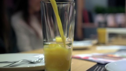 Wall Mural - Pouring orange juice into a glass, slow motion