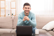 © Prostock-studio - Young Man Sitting At Laptop On Couch Indoor