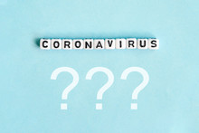 Coronavirus Word Next To Question Marks On Blue Background.