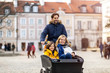 © pikselstock - Young family enjoying spending time together, riding in a cargo bicycle