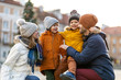 © pikselstock - Happy young family having fun outdoors during Christmas