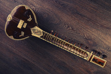 Indian Musical Instrument Sitar Lying On The Wooden Floor