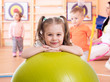 © Oksana Kuzmina - Smiling pretty child with fitness ball in gym. Gym class for preschool kids in kindergarten