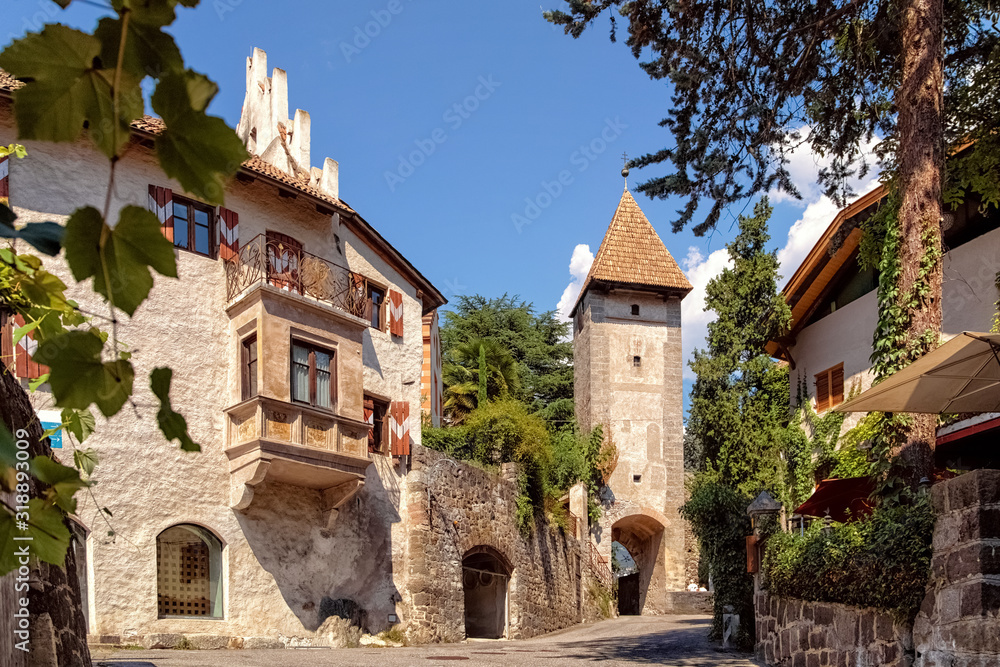 Old town gate Porta Passiria and part of the old town wall in Merano in South Tyrol, Italy - obrazy, fototapety, plakaty 