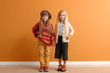 © Pixel-Shot - Cute little girls in autumn clothes near color wall