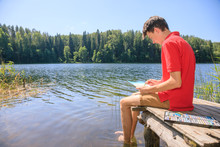 Teen Boy Sketching Summer Landscape With Pastel Sticks
