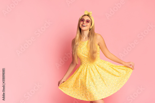Fotografía Cheerful young blonde woman dancing at pink studio