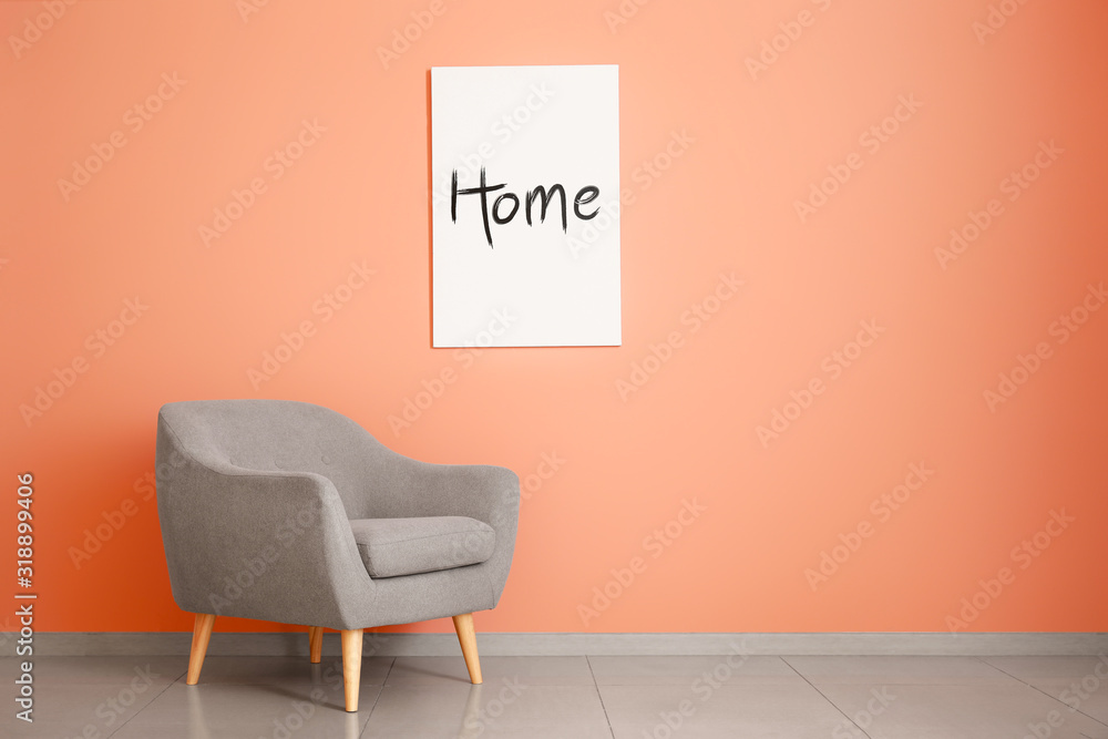 Stylish armchair near color wall in room