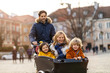 © pikselstock - Young family enjoying spending time together, riding in a cargo bicycle