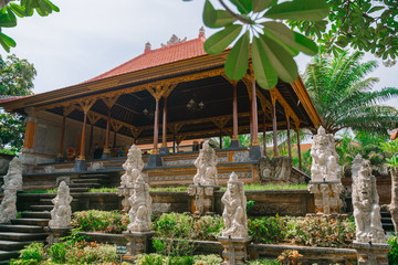 Traditional Balinese temple in Ubud. Ubud Place. Traditional Balinese architecture and statues of Balinese gods.