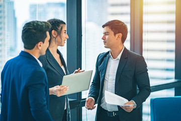 Group of business people having a work discussion indoors.	