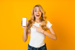 © Prostock-studio - Wow sales. Surprised woman pointing at blank phone screen