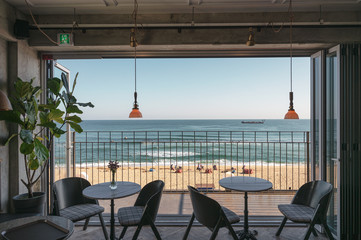 Table and chairs with wooden patio on the beach