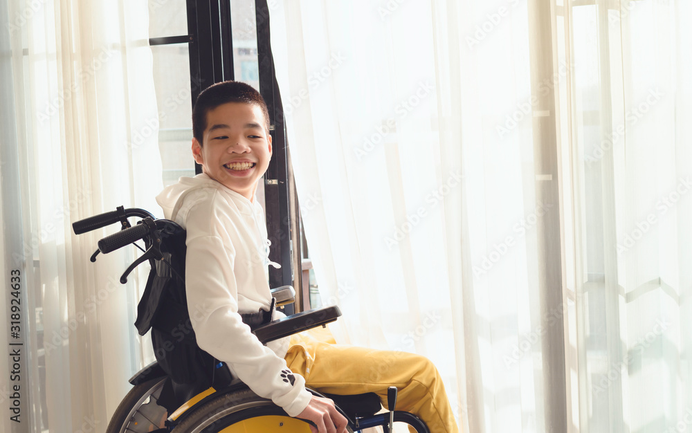 Asian special child on wheelchair is smile happily on The white curtain ...