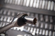 Socket wrench on shiny metallic silver background