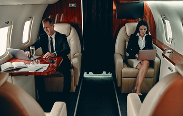 Business people in priate jet