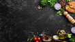 © Yaruniv-Studio - Black food background. Vegetables and spices on black background. Top view. Free space for your text.