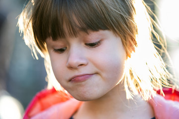 Portrait of a pretty child girl outdoors on a sunny warm autumn day.