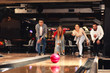 © djile - Group of young people having fun in a bowling alley
