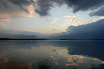 Wall Mural - Reflection of the sky in the lake water in the calmness at sunset