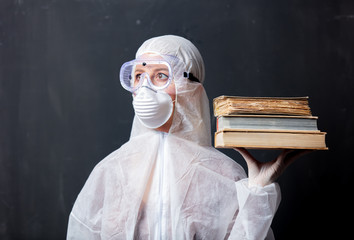 medic woman wearing protective clothing against the virus with books