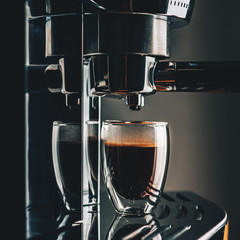 Freshly prepared portion of espresso in a glass glass, coffee machine