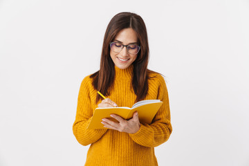 Sticker - Image of beautiful brunette adult woman making notes in diary book