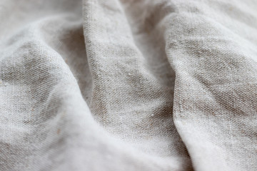 Natural linen fabric texture. Rough crumpled burlap background. Selective focus. Closeup view