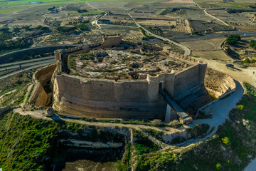 Wall Mural - Aerial view of Chinchilla de Montearagon castle with ruined excavated inner building remains surrounded by an outer wall with semi circular towers