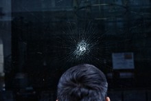 Close-Up Of Man At Cracked Window
