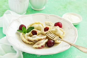 Wall Mural - Dumplings with cherries. Ukrainian and Belarusian cuisine.