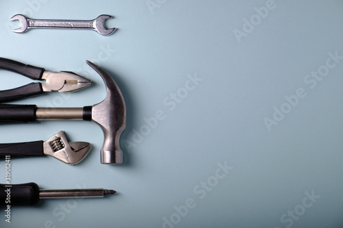 Fotografía Tools on a gray background, hammer, place for an inscription