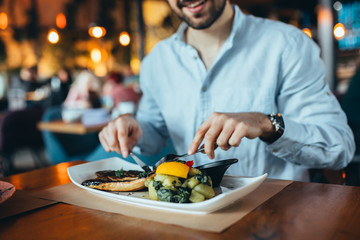 close up of man having lunch in restaurant