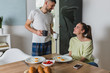 © cherryandbees - happy romantic couple having breakfast at home
