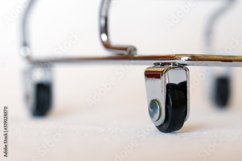 Fotografía Wheels of a small metal trolley, similar to a trolley for transporting corpses in a morgue or a medical device