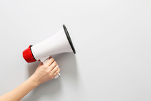 Female Hand With Megaphone On White Background