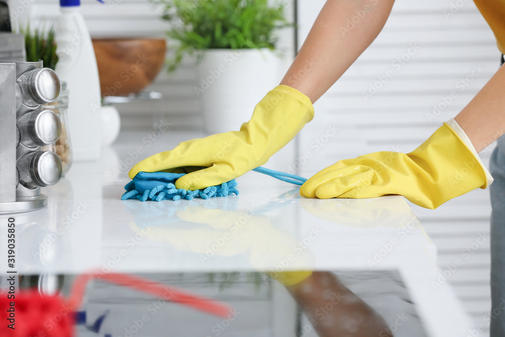 Young woman cleaning her kitchen