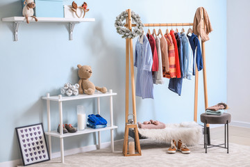 Interior of modern dressing room with winter clothes