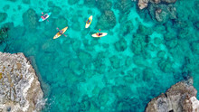 View Of A Drone From A Drone People Are Kayaking In The Sea Near The Mountains In A Cave With Turquoise Water On The Island Of Cyprus Ayia Napa