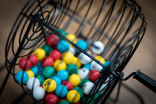 A Bingo Ball Cage With Colorful Balls Inside. 