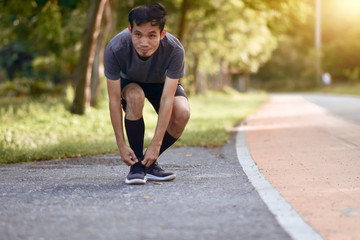 Wall Mural - Asian Runner man running in city park morning outdoors